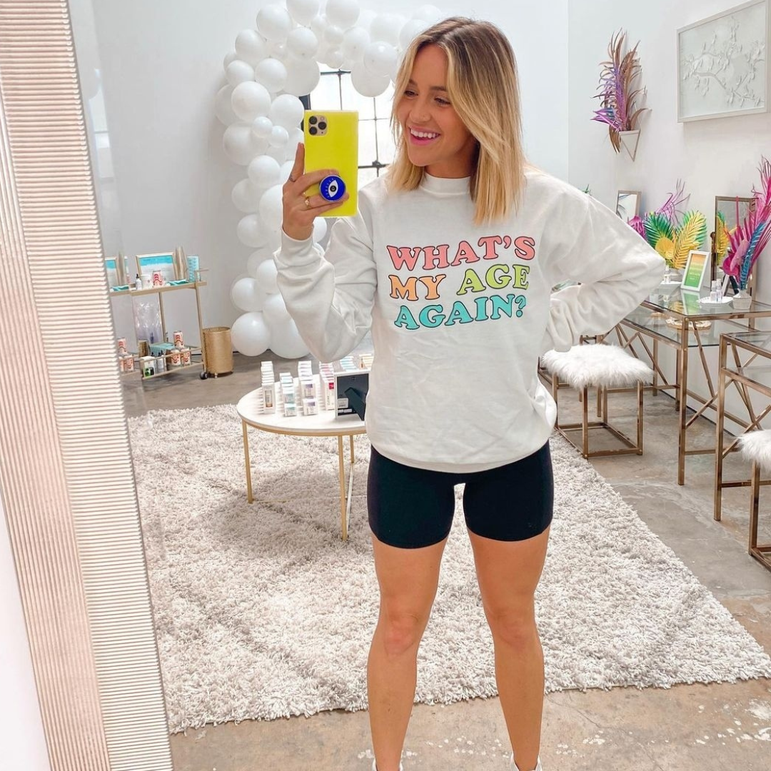a happy customer wearing what's my age again? sweatshirt by clearstem
